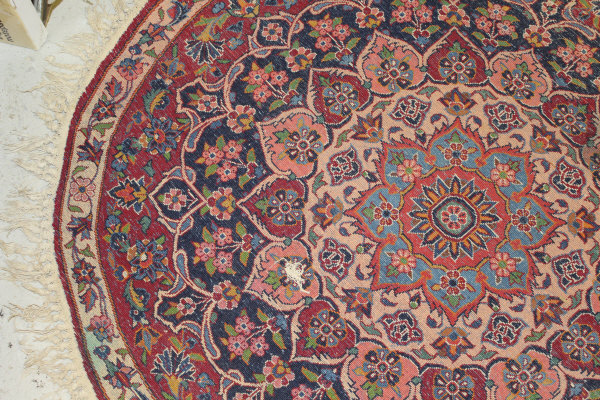 A Persian rug, the central panel set with stylised floral medallion on a red, blue and cream ground, - Image 15 of 34