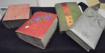A box containing four early 20th Century postcard albums containing various topographical postcards,