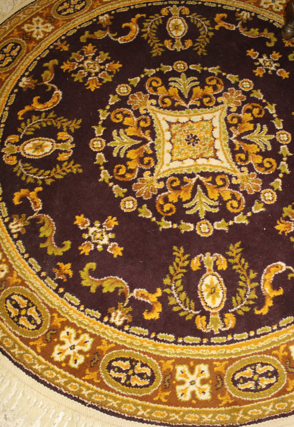 A Persian style rug, the central panel set with floral decorated medallion on an aubergine ground, - Image 2 of 2