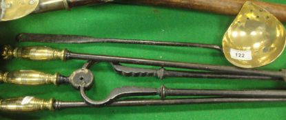A set of three circa 1800 brass-handled steel fire irons and an iron-handled brass strainer