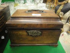 A George III mahogany tea caddy fitted with three lidded compartments raised on ogee bracket feet