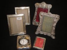 A pair of silver photo frames,