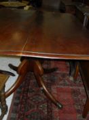 A 19th Century mahogany tilt-top tea table on turned central column to four splayed legs,