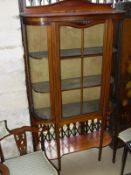 An Edwardian mahogany and satinwood strung display cabinet and two corner side chairs