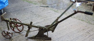 A cast iron horse-drawn plough