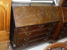 A late George III North Country oak and mahogany cross banded bureau,