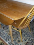 A light elm Ercol drop-leaf dining table on square sectioned beech legs,