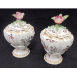 A pair of Sampson armorial lidded vases of squash form with flower finials raised on a circular