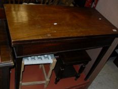 A 19th Century mahogany tea table on square section tapering legs,