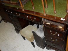A mahogany pedestal desk with green leather tooled inset top,