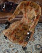 A Victorian mahogany framed salon chair with abstract tapestry style upholstery with serpentine