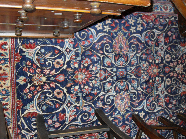 An Eastern rug, the central panel with all over foliate decoration on a midnight blue ground, - Image 2 of 9