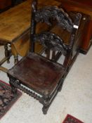 A mid 20th Century stained oak side chair with carved back,