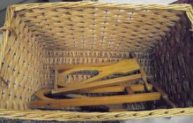 Two folding wooden boot jacks and a large wicker basket together with a "Music Alley" child's