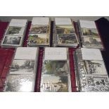 A box containing seven postcard albums containing various topographical postcards of varying