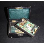 A leather jewellery box containing assorted jewellery to include a hardstone and pearl set ring