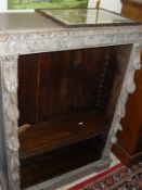 A Victorian painted and carved oak open bookcase in the gothic revival taste