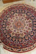 A Persian rug, the central panel set with stylised floral medallion on a red, blue and cream ground,