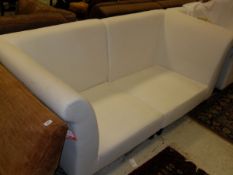 A pair of white ground three seater sofas by OKA with loose covers CONDITION REPORTS