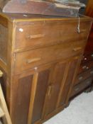 A carved oak sideboard with two drawers above two cupboard doors, raised on turned legs,