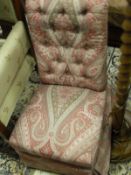 A Victorian nursing chair with paisley style pink/red upholstery,