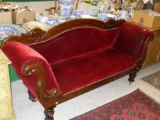 A Victorian mahogany framed scroll arm sofa with red velvet upholstery,