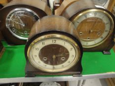 A collection of five various 1930's oak/walnut cased mantle clocks