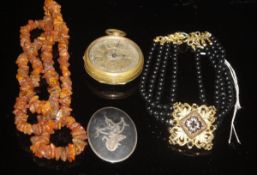 An amber chip necklace, brass pocket watch inscribed "John Forest London",