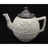 An early 19th Century relief ware bullet shaped pottery teapot with all over prunus blossom