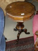 A Victorian mahogany trumpet shaped sewing table with lift top revealing fitted interior on three