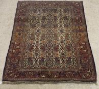 A Kashan rug, the central panel set with paisley style design on a cream ground,