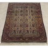 A Kashan rug, the central panel set with paisley style design on a cream ground,