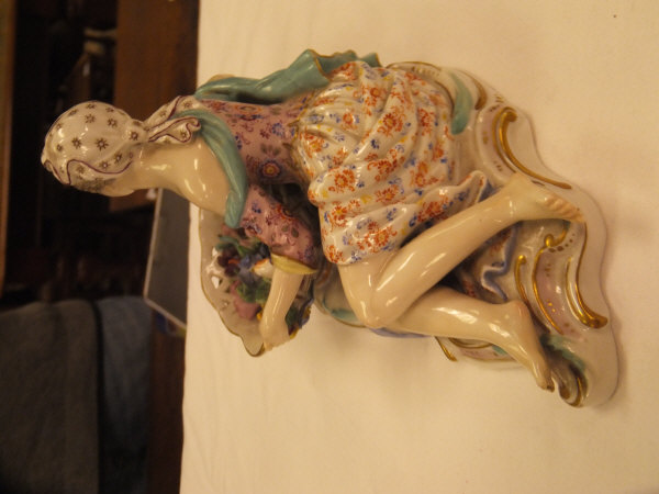 A pair of 19th Century Meissen figures as a recumbent gentleman and lady with baskets of flowers, - Image 25 of 48