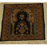 A fine silk prayer rug, the central panel set with Mihrab design on a black and cream ground,