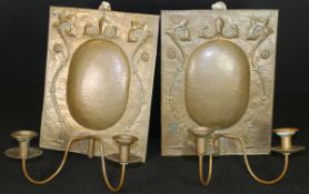 A pair of Edwardian Arts and Crafts Newlyn School copper wall sconces by John Pearson,