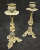 A pair of 19th Century gilt bronze candlesticks in the Rococo taste with facet shaped column set