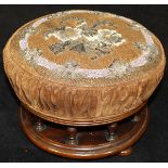 A Victorian needlework and bead decorated circular footstool on a galleried mahogany base,