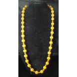An amber bead necklace, 85 cm long,
