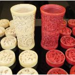A set of 19th Century Chinese carved ivory gaming pieces, each decorated with figures by trees,