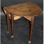 An 18th Century oak oval drop-leaf tea table with central bog oak and holly starburst inlaid