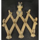 A Black Forest carved folding coat rack, the top decorated with carved Chamois head,