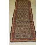 A Caucasian runner, the central panel set with repeating hook motifs on a cream ground,