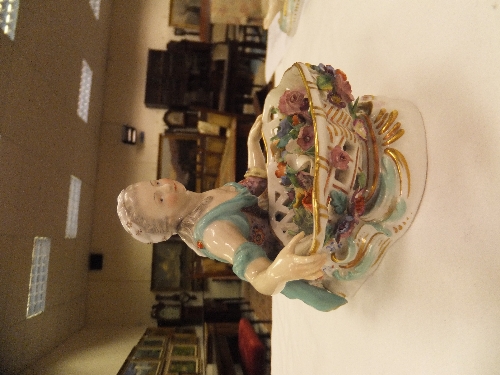 A pair of 19th Century Meissen figures as a recumbent gentleman and lady with baskets of flowers, - Image 27 of 48
