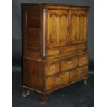 A 19th Century oak cupboard with Cavetto moulded cornice above two panelled doors enclosing a shelf,