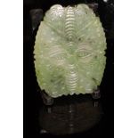 A Chinese spinach jade panel of insect or leaf form, carved to one side only, 4.