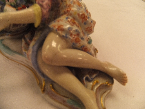 A pair of 19th Century Meissen figures as a recumbent gentleman and lady with baskets of flowers, - Image 32 of 48