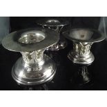 A modern three piece table suite comprising two candlesticks and a bowl,