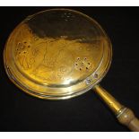 A late 17th/early 18th Century brass bed warming pan with pierced and engraved cover and turned