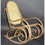 An early 20th Century bentwood rocking chair in the manner of Thonet with cane seat and back, 52.