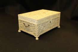 A mid 19th Century Chinese carved ivory sewing casket profusely and finely carved with a procession